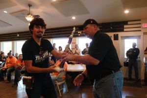 KIM & DOUG WYMAN PRESENTING AWARDS AT the 2017 October Corridor Clay Crushers tournament - 2nd Annual Pheasants Forever shootout hosting 9 collegiate trap teams at Otter Creek in Cedar Rapids Iowa. Award to Manning